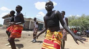 Fusion between culture and modernity as children dance in Kenyan refugee camp